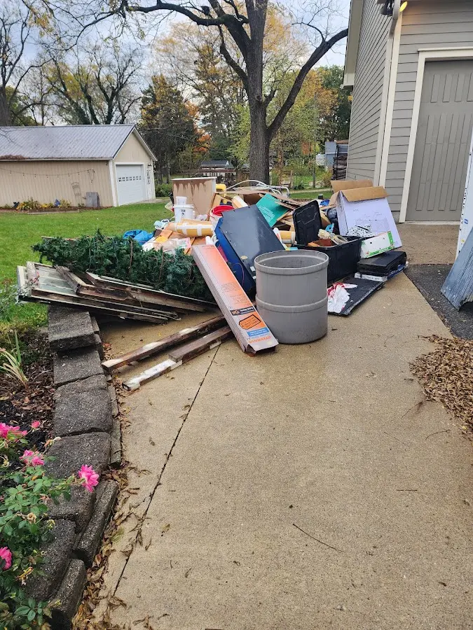 Dumpster being loaded with debris for 3 Yard Dumpster Rental in Saline